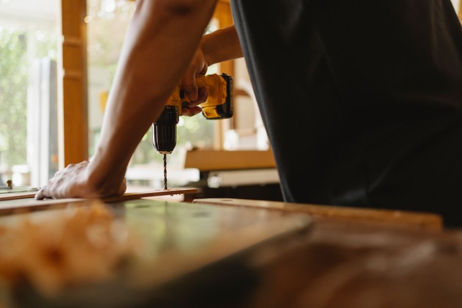 Carpenter carefully installing a wooden door frame
