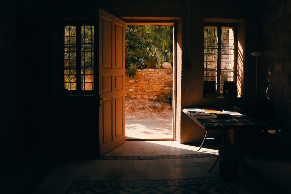 Open front door letting in bright sunlight
